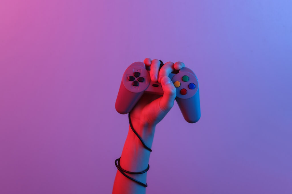 hands-holding-retro-joystick-blue-red-neon-gradient-light-old-gaming-80s-retro-wave-minimalism