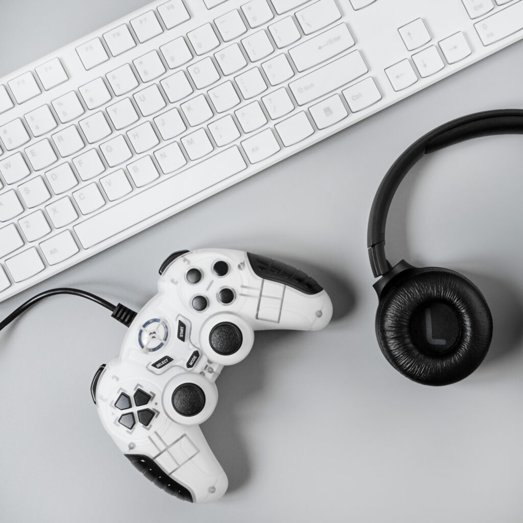 headphones-joystick-keyboard-gray-surface-gamer-workspace-concept-top-view-gaming-gear