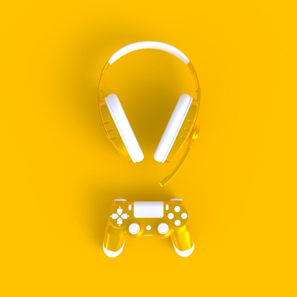 yellow-joystick-with-yellow-headphones-yellow-table-background